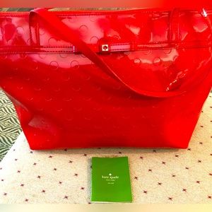 Bright red Kate Spade patent leather bag in good used condition. Wear is shown.